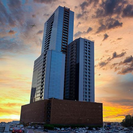 Luxe Grand Hotel Apartments Шарджа Экстерьер фото The building at sunset